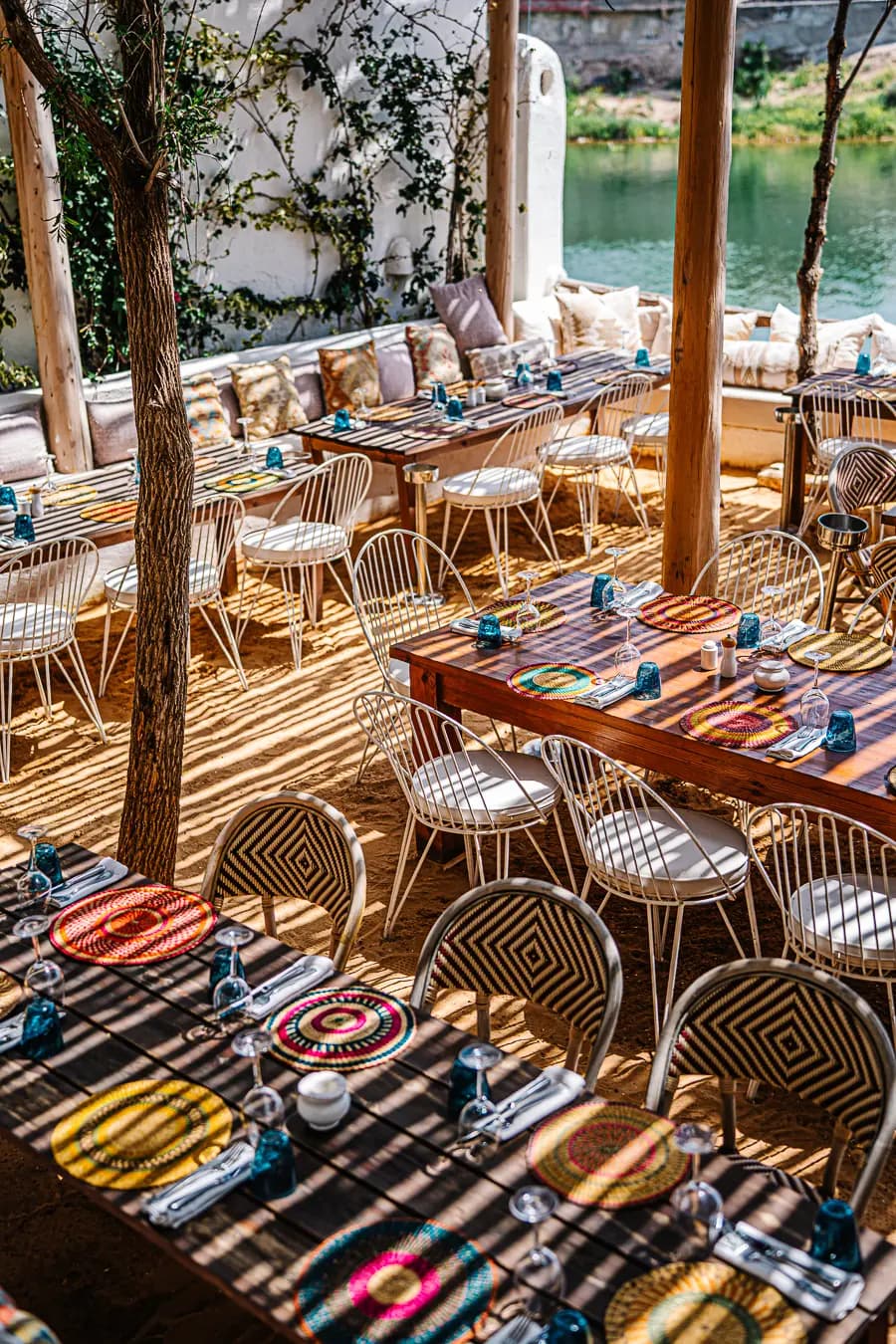 Mykonos-Inspired Boho-Chic Lounge Oasis Mykonos-inspired boho-chic lounge setup offering a relaxing VIP desert oasis experience